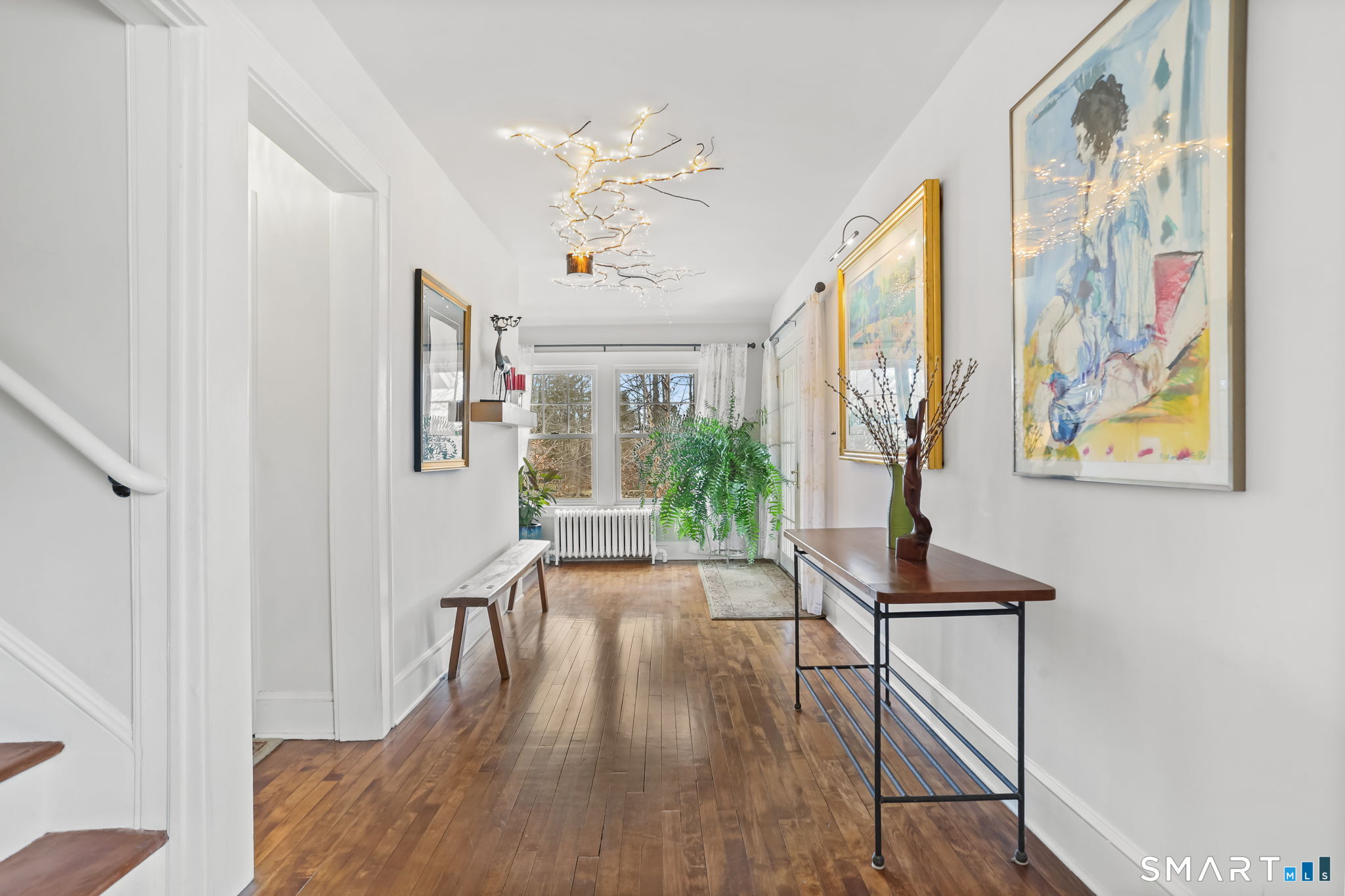 98 Comstock Hill Avenue Norwalk, CT 06850 - Photo 10 of 40 a view of a hallway with wooden floor and staircase