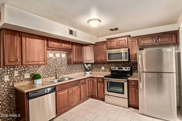 a kitchen with a sink appliances and cabinets