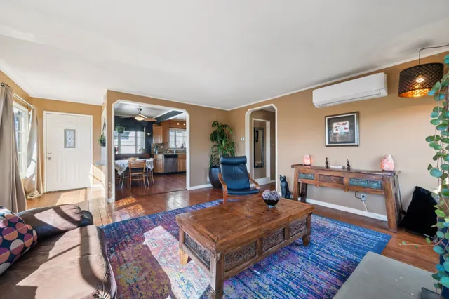 a living room with furniture a rug and a wooden floor