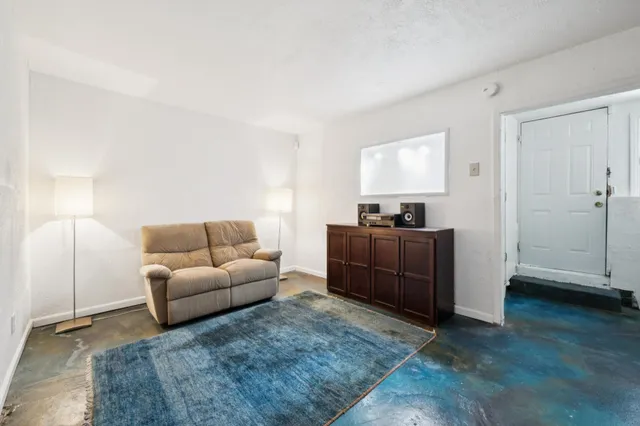 a bedroom with furniture and a window