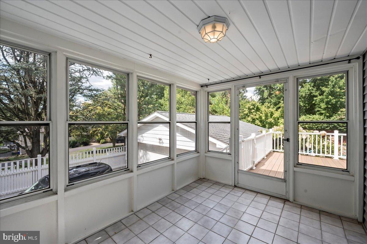 59 West Macada Road Bethlehem, PA 18017 - Photo 10 of 31 Bright sunroom with serene outdoor views.