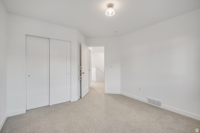 1058 Lilac Way Mapleton, UT 84664 - Photo 17 of 28 Unfurnished bedroom with a closet and light carpet