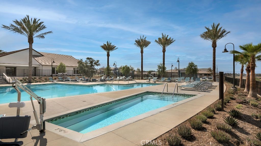 32105 Hyacinth Way Temecula, CA 92591 - Photo 15 of 19 a view of a swimming pool with a table and chairs