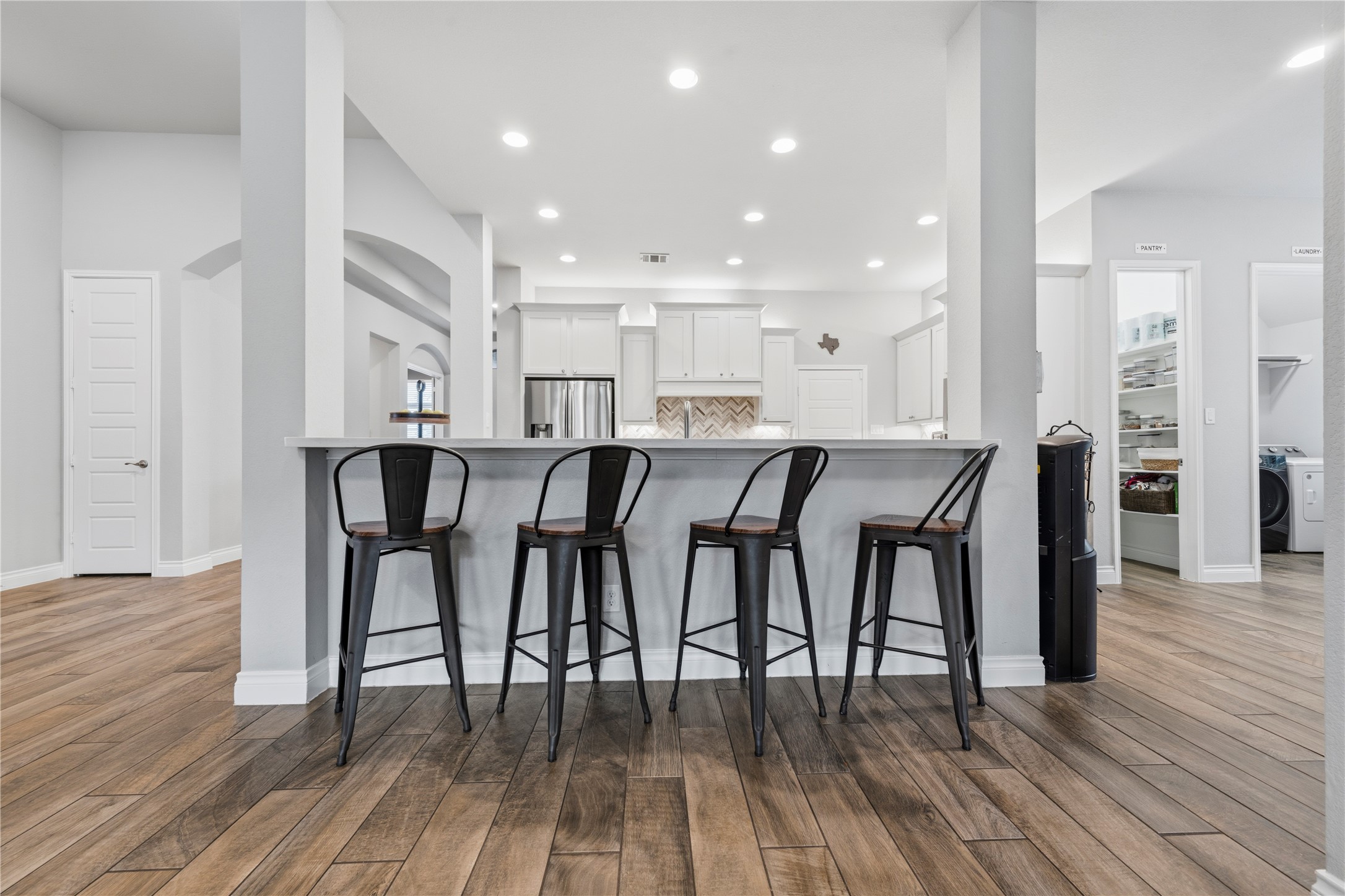140 Catani Loop Georgetown, TX 78628 - Photo 11 of 36 A well-appointed kitchen features a large breakfast bar overlooking the living space, creating an inviting atmosphere.