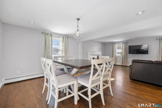 a view of a dining room with furniture and wooden floor