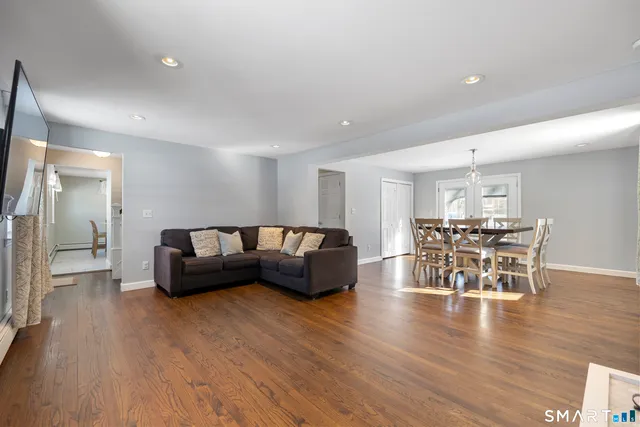 a living room with furniture and wooden floor