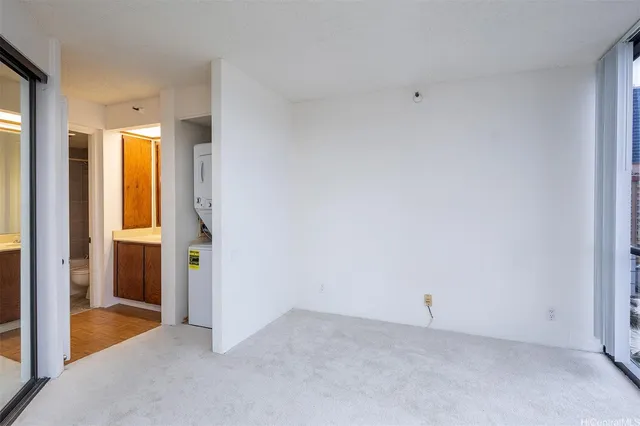 an empty room with windows and closet