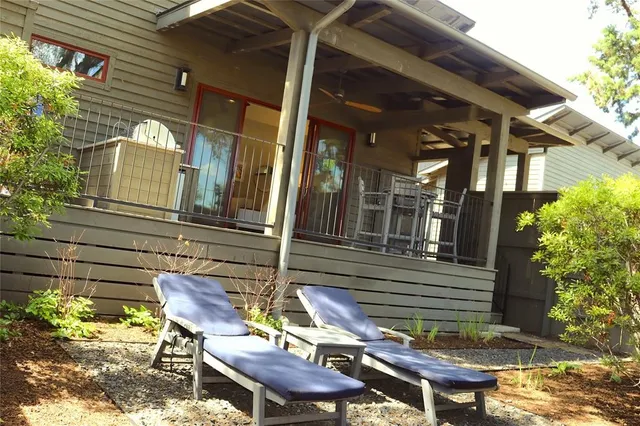 a view of house with a chairs and table in a patio