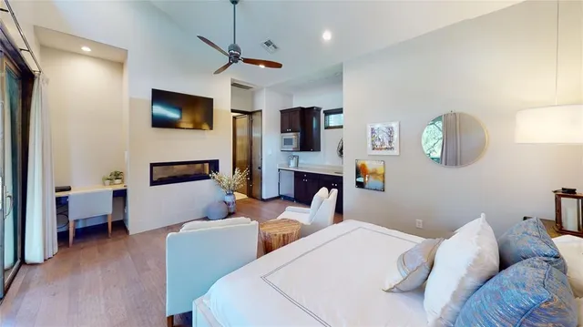 a bedroom with furniture and a flat screen tv