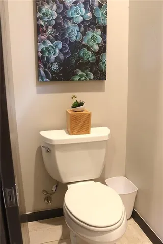 a toilet sitting next to a white wall