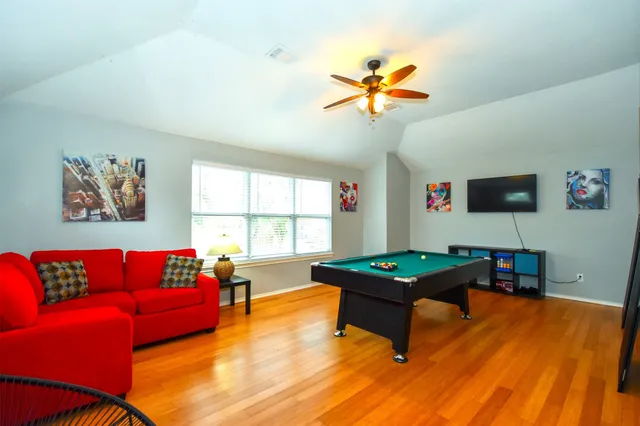 a dining room with furniture and wooden floor