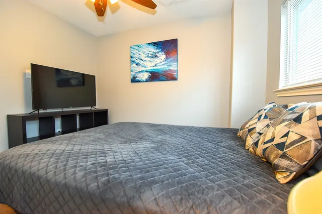 a bedroom with a bed and a chandelier