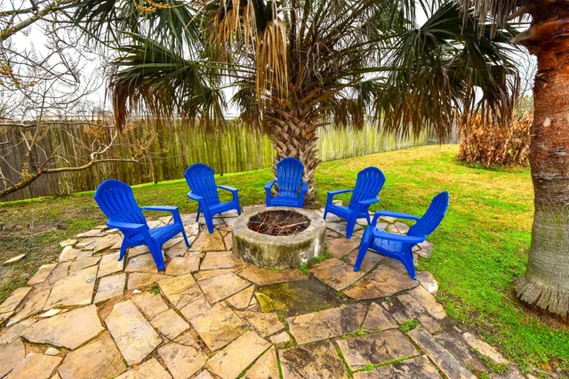 a swimming pool with outdoor seating and yard