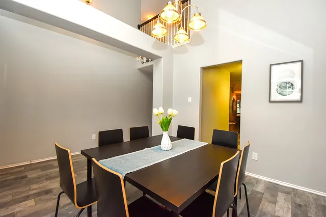 a view of a dining room with a table and chairs