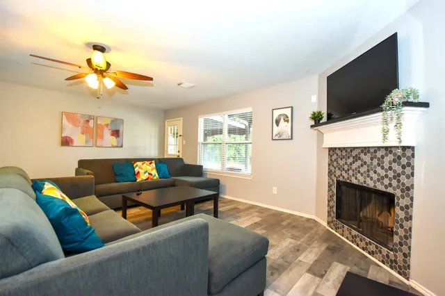 a living room with furniture and a flat screen tv
