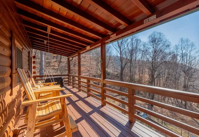 a view of a balcony with chairs and wooden floor