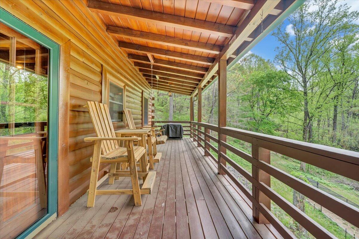 13357 Callaway Road Callaway, VA 24067 - Photo 4 of 62 a view of a balcony with chairs and wooden floor