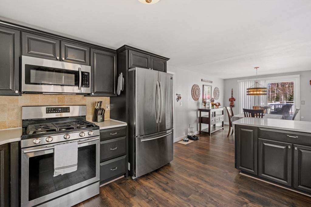 40 Gaita Drive Derry, NH 03038 - Photo 13 of 34 a kitchen with granite countertop a refrigerator stove and microwave