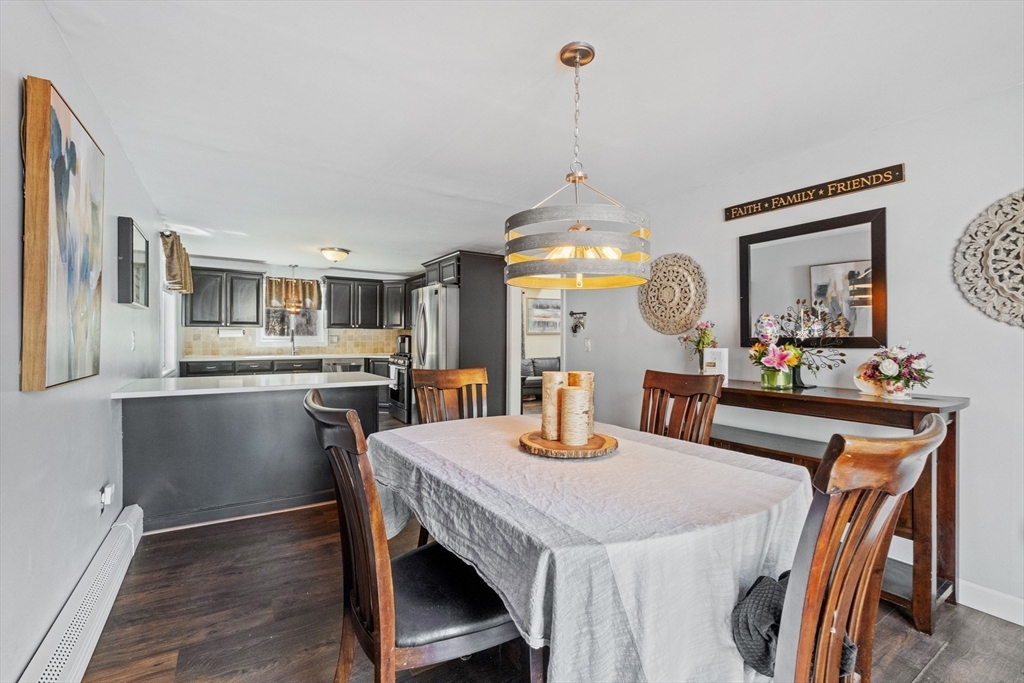 40 Gaita Drive Derry, NH 03038 - Photo 14 of 34 a view of a dining room and livingroom with furniture wooden floor a chandelier