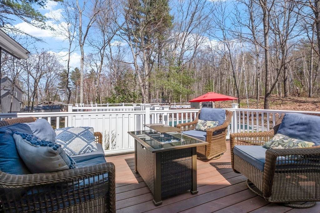 40 Gaita Drive Derry, NH 03038 - Photo 16 of 34 a view of a patio with couches table and chairs and wooden floor