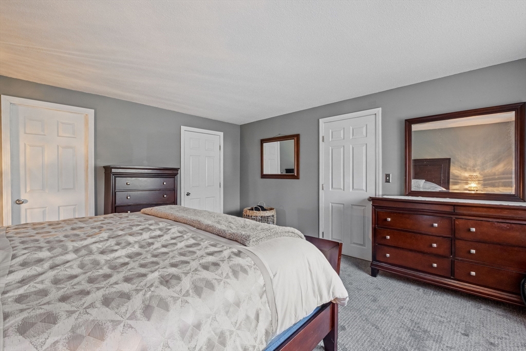 40 Gaita Drive Derry, NH 03038 - Photo 21 of 34 a bedroom with a bed and a large mirror on dresser