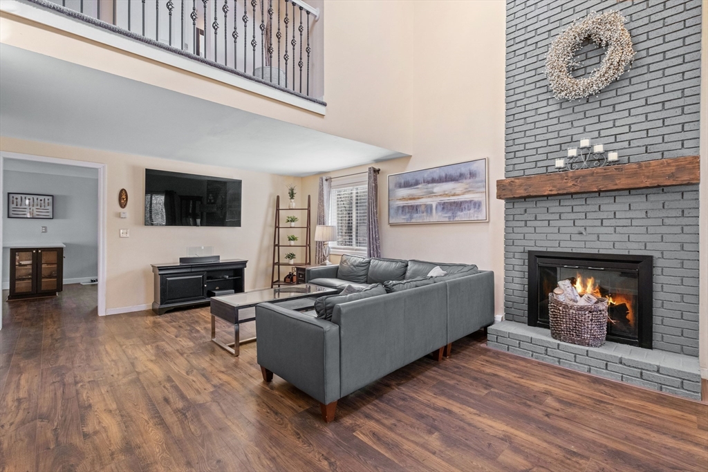 40 Gaita Drive Derry, NH 03038 - Photo 8 of 34 a living room with furniture a fireplace and a flat screen tv