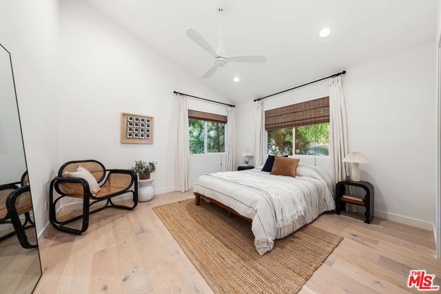 a bedroom with a bed a couch and a window