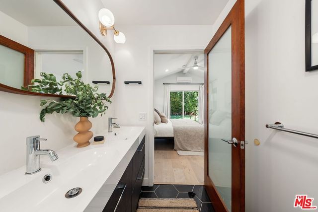 a bath room with a sink and a mirror