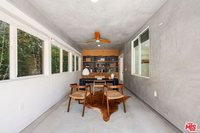 a dining room with furniture and window