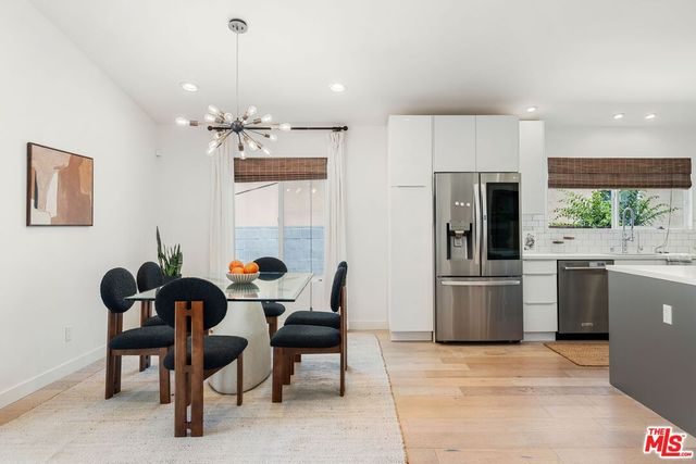 a view of kitchen with refrigerator microwave and cabinets