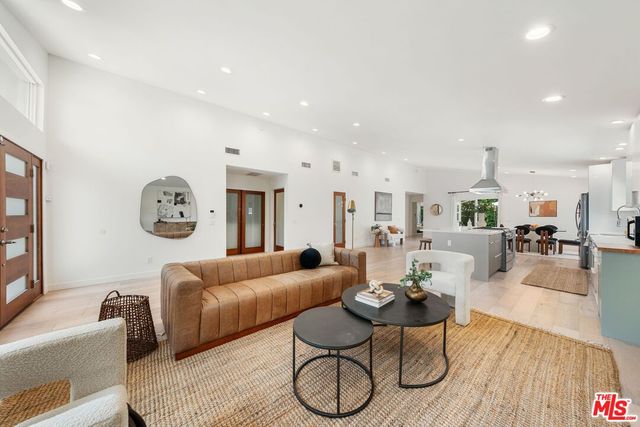 a living room with furniture a rug and a table