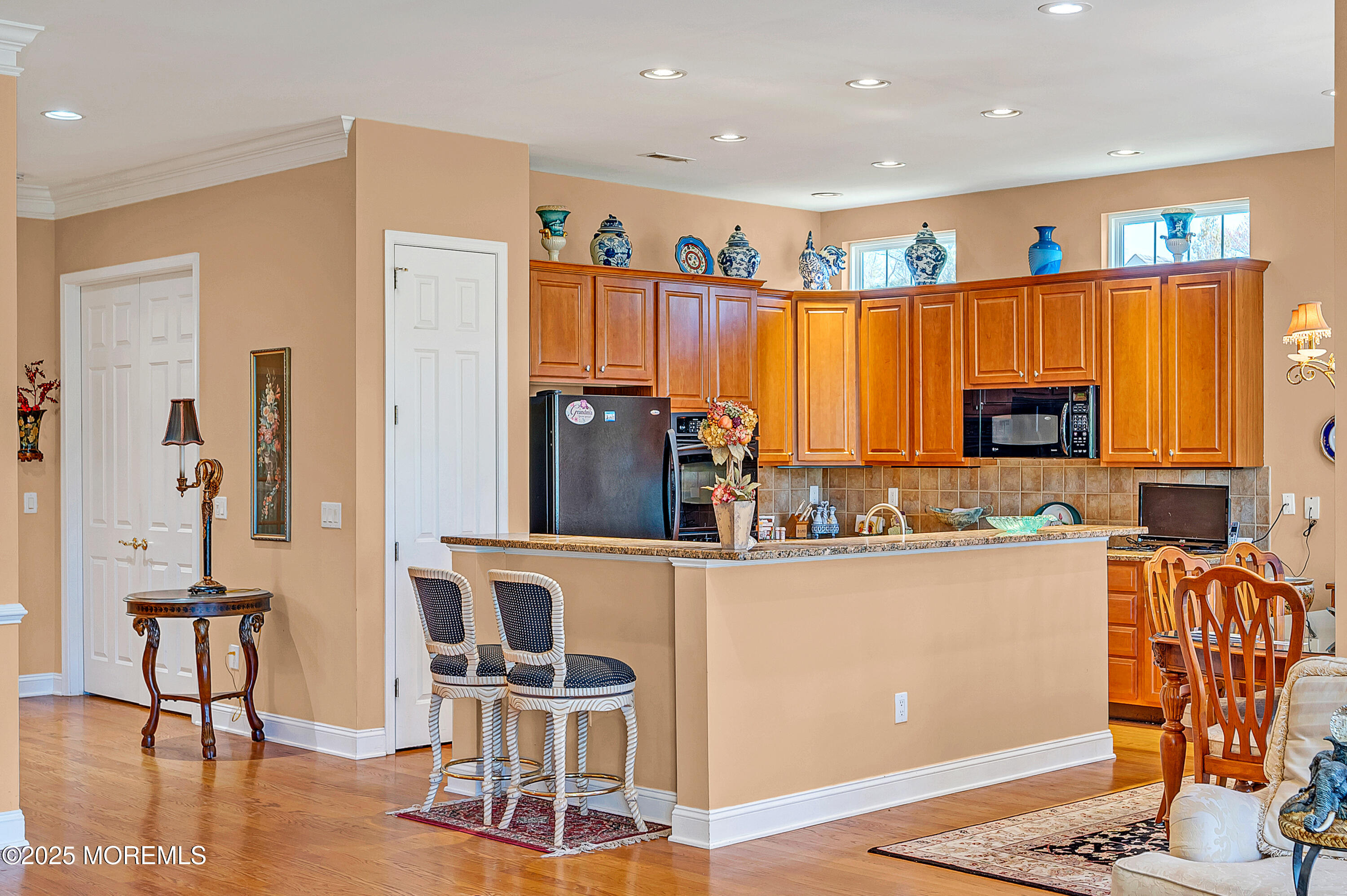 2 Carleton Drive Freehold, NJ 07728 - Photo 11 of 40 a living room with stainless steel appliances kitchen island granite countertop furniture and a flat screen tv