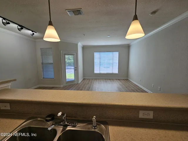 a room with pool table and windows