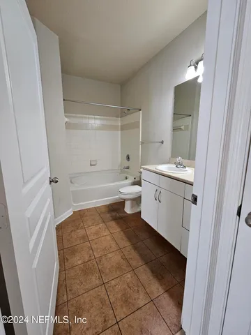 a bathroom with a sink a toilet and a shower