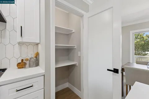 a kitchen with sink a refrigerator and chairs