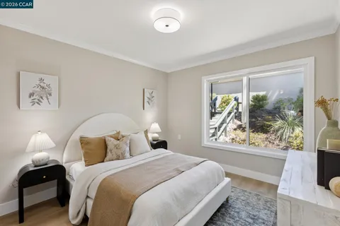 a bedroom with a bed and a large window