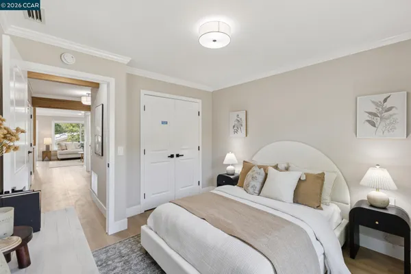 a bedroom with a bed and large windows