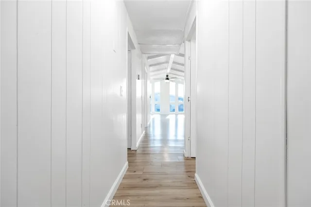 a view of a room with wooden floor and a window