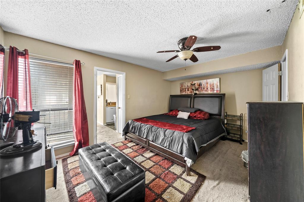 9811 Walnut Street, Unit 201 Dallas, TX 75243 - Photo 10 of 15 a bedroom with a bed dresser and a window
