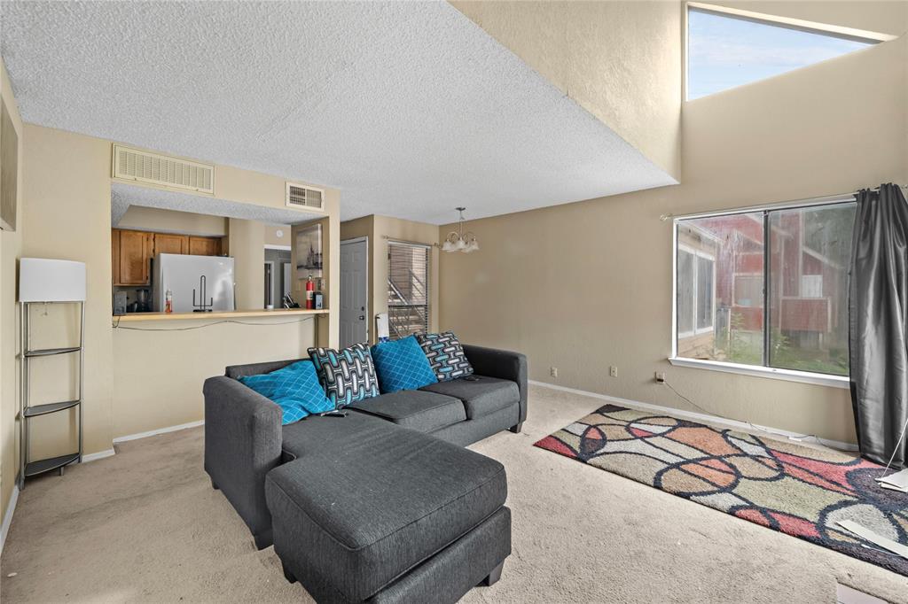 9811 Walnut Street, Unit 201 Dallas, TX 75243 - Photo 2 of 15 a living room with furniture and a flat screen tv