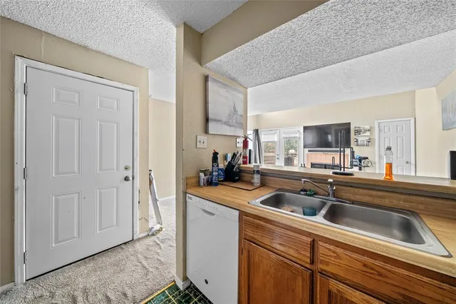 a kitchen with a stove a sink and a refrigerator