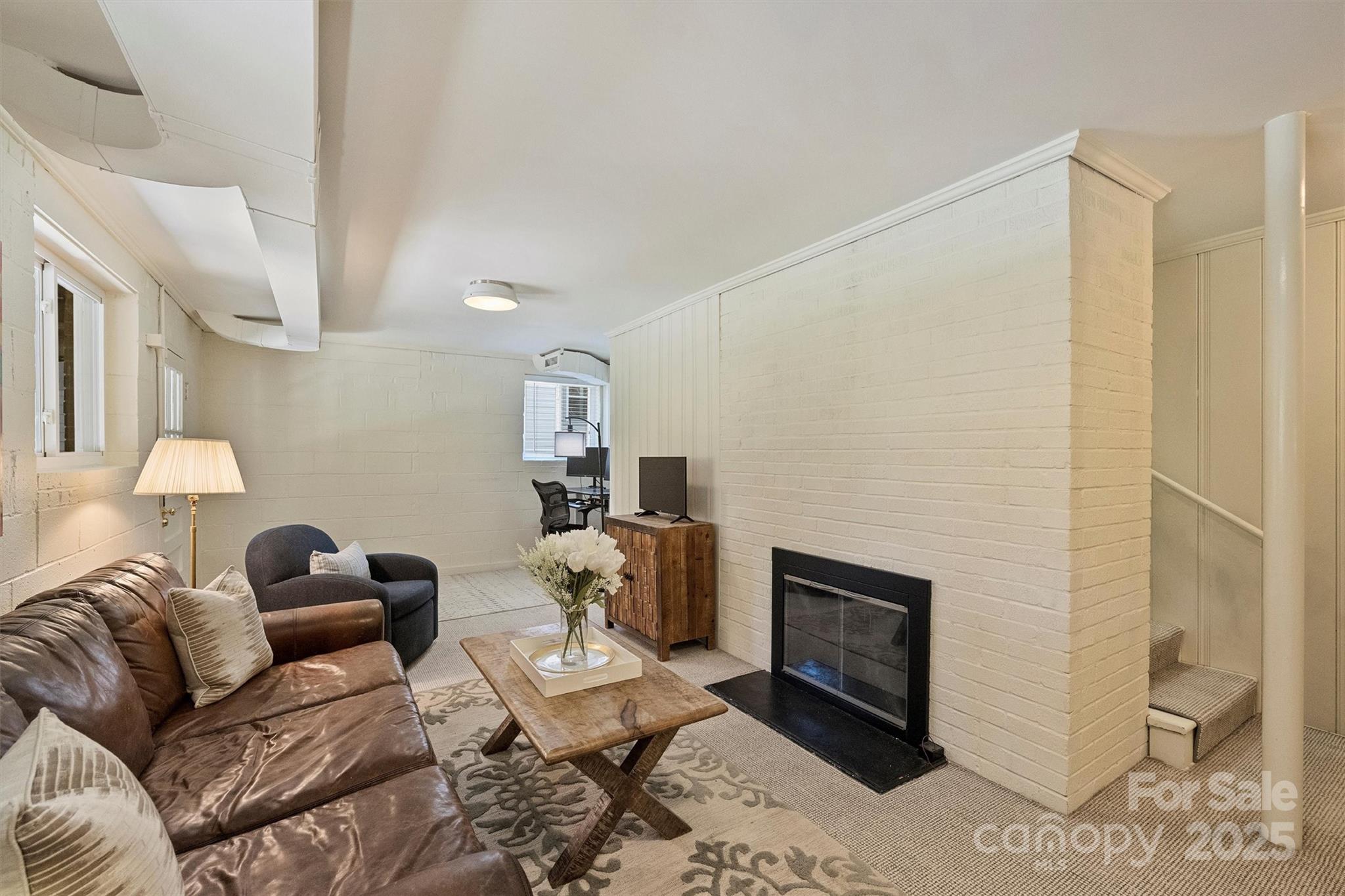 138 Scofield Road Charlotte, NC 28209 - Photo 24 of 36 a living room with furniture and a fireplace