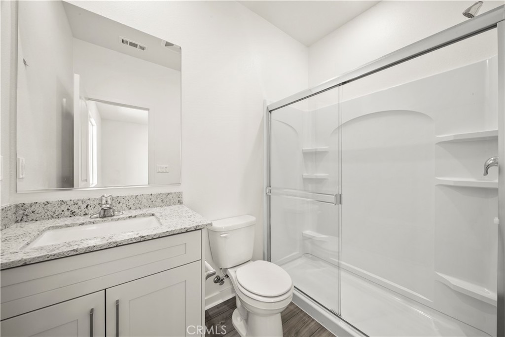 42484 Isla Court Indio, CA 92201 - Photo 11 of 16 a bathroom with a granite countertop sink toilet and shower