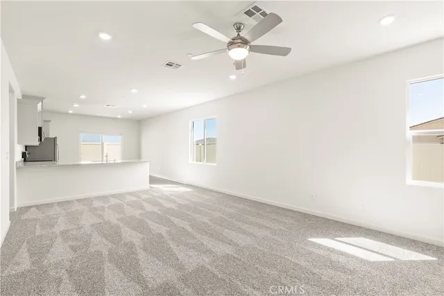 a kitchen with granite countertop white cabinets a sink a window and stainless steel appliances