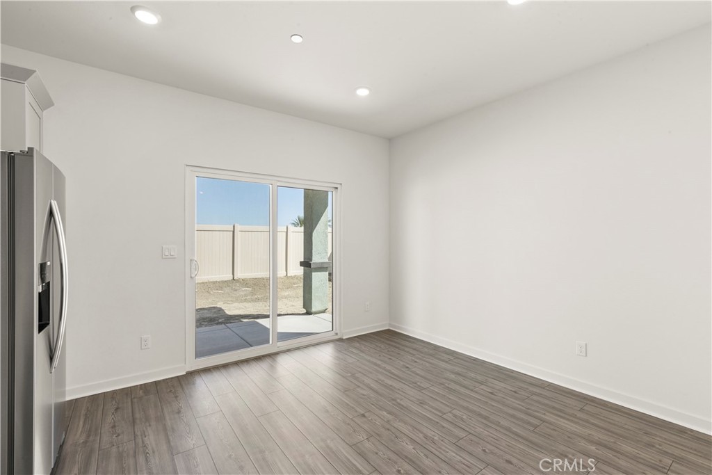 42484 Isla Court Indio, CA 92201 - Photo 7 of 16 a view of wooden floor and windows in a room