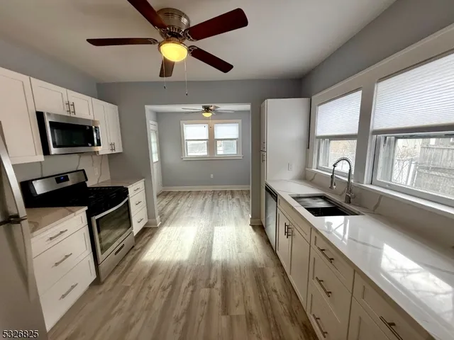 a kitchen with a stove a sink and a microwave