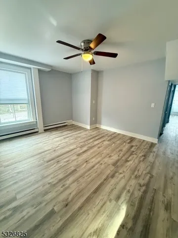 a view of a livingroom with a ceiling fan and window