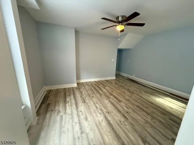 a view of room with window and ceiling fan