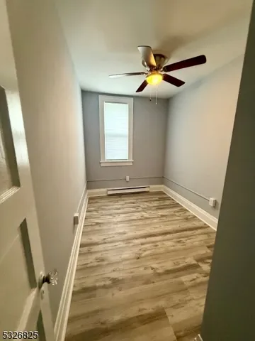 a view of a livingroom with a ceiling fan and window