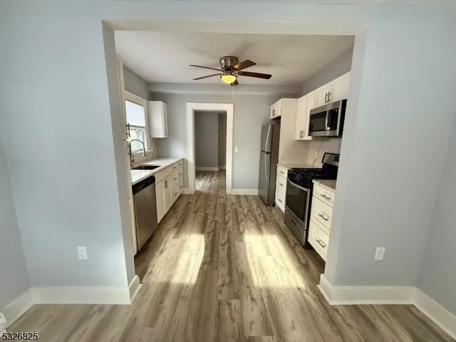 a view of a kitchen from the hallway